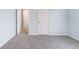 Bedroom features gray carpet, natural light, and open doorway at 4865 Fourth Rail Ln, Cumming, GA 30040