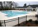 Large community pool with lap lanes and mushroom fountains and nearby clubhouse at 4865 Fourth Rail Ln, Cumming, GA 30040