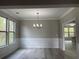 Dining room with white wainscoting and modern light fixture at 4865 Fourth Rail Ln, Cumming, GA 30040