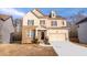 Two-story house with brick and tan siding, an attached two-car garage, and a well-maintained lawn at 4865 Fourth Rail Ln, Cumming, GA 30040