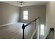 Bright upstairs hallway with neutral walls and a ceiling fan at 4865 Fourth Rail Ln, Cumming, GA 30040