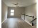 Bright upstairs hallway with neutral walls and a ceiling fan at 4865 Fourth Rail Ln, Cumming, GA 30040