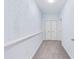Hallway featuring neutral carpeting, fresh paint, a utility shelf, and closet at 4865 Fourth Rail Ln, Cumming, GA 30040