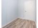 Small bonus room featuring gray walls and wood-look flooring with a white door at 4865 Fourth Rail Ln, Cumming, GA 30040