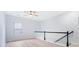 Upstairs hallway with a large window, gray walls, and black and white railing at 4865 Fourth Rail Ln, Cumming, GA 30040