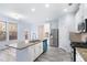 Kitchen with stainless steel appliances, granite counters, an island, and gray floors at 4865 Fourth Rail Ln, Cumming, GA 30040