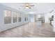 Open concept living room and kitchen with granite counters, large windows and gray floors at 4865 Fourth Rail Ln, Cumming, GA 30040