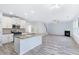 Open concept living room and kitchen with granite counters, fireplace and gray floors at 4865 Fourth Rail Ln, Cumming, GA 30040