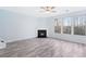 Living room with gray walls, wood-look flooring, and fireplace, with large picture windows at 4865 Fourth Rail Ln, Cumming, GA 30040