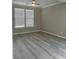 Bright living room with laminate floors and lots of natural light at 4865 Fourth Rail Ln, Cumming, GA 30040