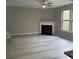 Living room featuring a modern fireplace, laminate floors, and large windows at 4865 Fourth Rail Ln, Cumming, GA 30040