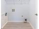 Small, bright utility room with wood-look floors, plus washer and dryer hookups at 4865 Fourth Rail Ln, Cumming, GA 30040