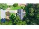 Aerial view of a home with mature trees, showcasing the roof and lot at 1066 Sea Oats Sw Way, Lilburn, GA 30047
