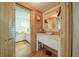 Hallway leading to bathroom featuring vanity with white cabinets, wood countertop, and stylish decor at 1066 Sea Oats Sw Way, Lilburn, GA 30047