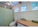 Well-lit bathroom with wainscotting, beadboard ceiling, a vanity with wood countertop, and stylish shower curtain at 1066 Sea Oats Sw Way, Lilburn, GA 30047