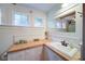 Bright bathroom featuring a sink with a vanity, natural wood countertop, and vintage-inspired decor, exudes warmth and charm at 1066 Sea Oats Sw Way, Lilburn, GA 30047