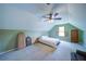 A cozy bedroom features unique ceiling design with a ceiling fan and a bed by the window at 1066 Sea Oats Sw Way, Lilburn, GA 30047