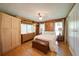 Charming bedroom with wood accents, hardwood floors, and natural light from the windows, creates a cozy retreat at 1066 Sea Oats Sw Way, Lilburn, GA 30047