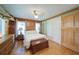 Sunlit bedroom with wood walls, hardwood floors, bedside tables and lamps, offering a relaxing and comfortable space at 1066 Sea Oats Sw Way, Lilburn, GA 30047