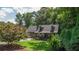 Charming Cape Cod-style home with a manicured lawn and mature trees at 1066 Sea Oats Sw Way, Lilburn, GA 30047
