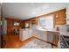 Bright kitchen featuring stainless appliances, tile backsplash, granite countertops and a farmhouse sink at 1066 Sea Oats Sw Way, Lilburn, GA 30047
