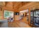 Spacious living room with wood paneling, hardwood floors, and an open floor plan to the kitchen and other rooms at 1066 Sea Oats Sw Way, Lilburn, GA 30047
