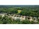 Aerial view shows the neighborhood nestled amongst lush greenery at 1810 Stardust Trl, Cumming, GA 30040