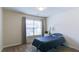 Well-lit bedroom featuring neutral paint and carpet, with a bed placed near the window at 1810 Stardust Trl, Cumming, GA 30040