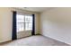 Bright bedroom with a large window offering natural light and neutral carpeting at 1810 Stardust Trl, Cumming, GA 30040