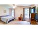 Cozy bedroom with plush carpeting, large windows, ceiling fan, and neutral paint at 1810 Stardust Trl, Cumming, GA 30040