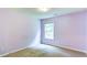 Comfortable bedroom with neutral paint and carpet, featuring a single window for natural light at 1810 Stardust Trl, Cumming, GA 30040