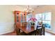 Sunlit dining room featuring a classic china cabinet and charming chandelier at 1810 Stardust Trl, Cumming, GA 30040