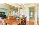 Cozy dining room showcasing hardwood floors, a rustic chandelier, and ample natural light at 1810 Stardust Trl, Cumming, GA 30040