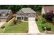 Charming two-story home with a well-manicured lawn and mature trees offering curb appeal at 1810 Stardust Trl, Cumming, GA 30040