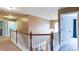 Hallway with carpeted floor and wood railing at 1810 Stardust Trl, Cumming, GA 30040