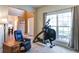Comfortable home gym with exercise equipment, recliner chair and large window at 1810 Stardust Trl, Cumming, GA 30040