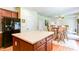 Open kitchen concept with cherry wood island and breakfast table with seating at 1810 Stardust Trl, Cumming, GA 30040