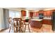 Charming kitchen with wooden cabinets, hardwood floors, and a cozy breakfast nook at 1810 Stardust Trl, Cumming, GA 30040