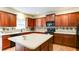 Bright kitchen with ample wood cabinetry, large center island, and modern appliances at 1810 Stardust Trl, Cumming, GA 30040