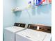 Laundry area with washer, dryer, and storage shelf at 1810 Stardust Trl, Cumming, GA 30040