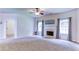 Open living room featuring carpet floors, fireplace and views to back yard at 1810 Stardust Trl, Cumming, GA 30040