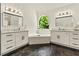 Elegant bathroom featuring dual sinks, marble countertops, and a luxurious soaking tub with a picturesque window view at 2055 Beacon Hill Way, Alpharetta, GA 30005