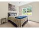 Bright bedroom with a comfortable bed, side table, and a view of the lush outdoors at 2055 Beacon Hill Way, Alpharetta, GA 30005