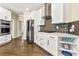 Kitchen with gas range, white cabinets, stainless appliances, and open floor plan at 2055 Beacon Hill Way, Alpharetta, GA 30005
