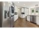 Spacious kitchen with stainless steel appliances, white cabinets, and hardwood floors at 2055 Beacon Hill Way, Alpharetta, GA 30005