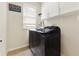Laundry room features modern washer/dryer, storage cabinets, and a bright window at 2055 Beacon Hill Way, Alpharetta, GA 30005
