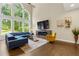 Bright living room features floor to ceiling windows and a modern fireplace at 2055 Beacon Hill Way, Alpharetta, GA 30005