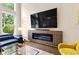 Living room with large windows, modern fireplace and television at 2055 Beacon Hill Way, Alpharetta, GA 30005