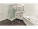 Bright main bathroom featuring a shower, soaking tub and modern vanity at 2055 Beacon Hill Way, Alpharetta, GA 30005