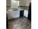 Clean kitchen featuring white cabinets, stainless steel sink, black appliances, and gray flooring at 2475 Cajun Dr, Marietta, GA 30066